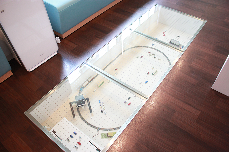 待合室の床下に列車が走っています。